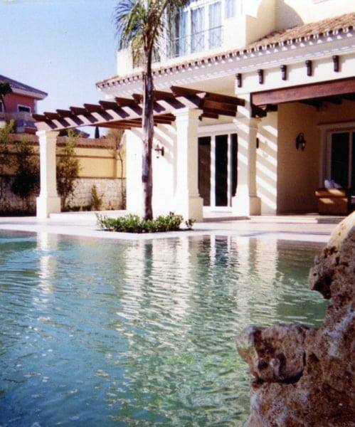 zero-edge pool with stone terrace and natural rock