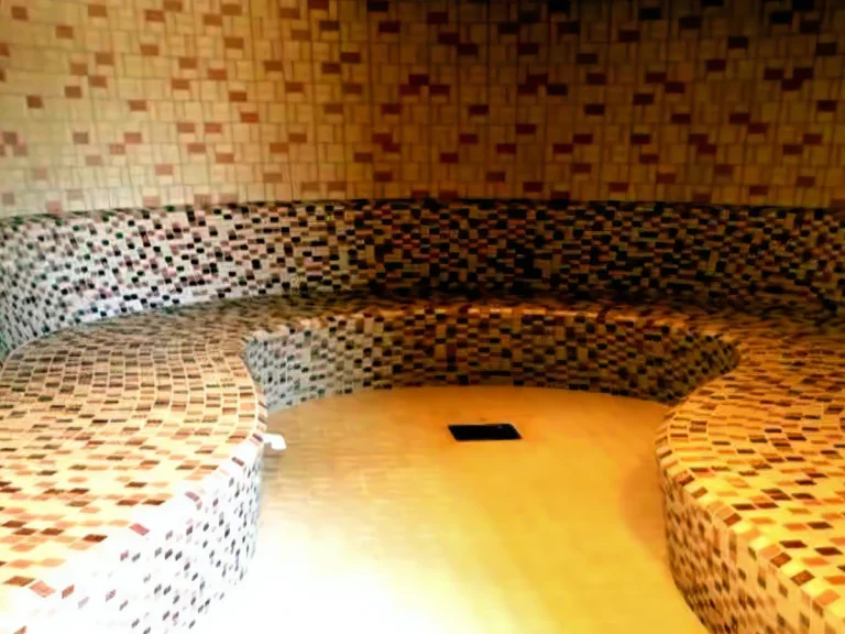 Interior view of a curved mosaic-tiled hammam built as part of a luxury infinity pool project in Bahrain