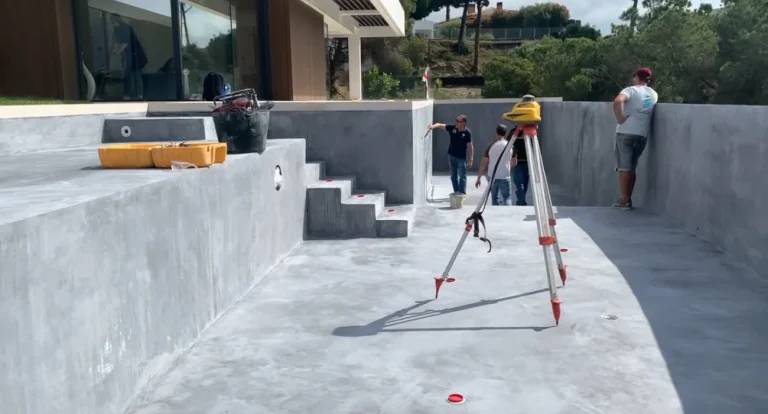 Checking overflow levels with laser during pool shell construction