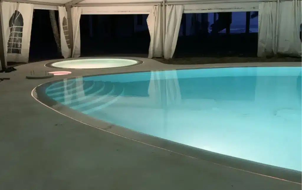 Zero-edge pool perimeter overflow slot at deck level — Morana Water Design