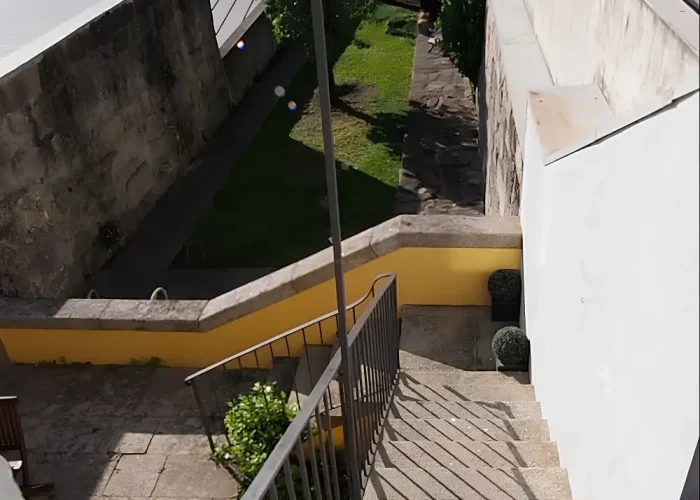 View of the Porto garden before construction, with terraced levels and surrounding stone walls