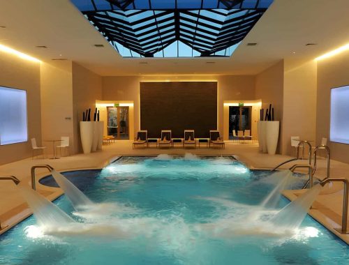 Zero-edge hydrotherapy pool at Movenpick Tala Bay Resort in Aqaba, Jordan, with custom mosaic and therapeutic water features